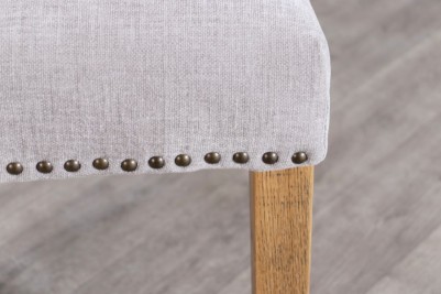 grey chair with brass studs